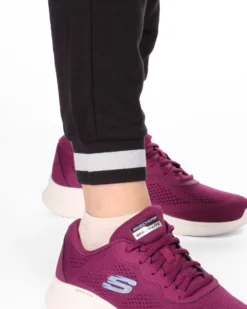 PUMA - Tuta completa da donna bianca e nera con zip frontale e dettagli argento glitter
